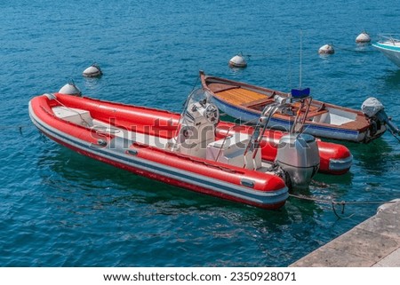 Sunny scenery including two boats at Lake Garda in Northern Italy