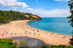 A Sunny Seascape With People Enjoying The Beach In Blackpool Sands, Devon.