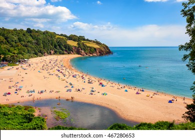 A Sunny Seascape With People Enjoying The Beach In Blackpool Sands, Devon.