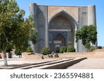 Sunny September day at the main portal of the medieval Bibi Khanum madrasah (1404). Samarkand, Uzbekistan