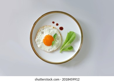 Sunny side up egg on white plate top angle view on white background. Fried egg with vegetable and soya sauce for breakfast - Powered by Shutterstock