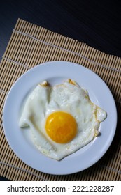 Sunny Side Up Eggs On A White Plate. As A High Protein Breakfast Menu