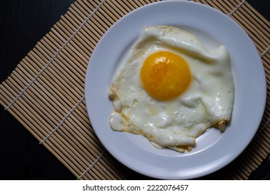 Sunny Side Up Eggs On A White Plate. As A High Protein Breakfast Menu