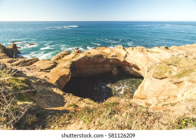 Sunny Summer Day At Devil's Punch Bowl State Park Near Newport, Oregon, USA. Ocean Waves And Sunny Blue Sky Above.