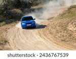 Sunny summer day. Dusty rally track. A rally car makes a lot of dust in a turn 18