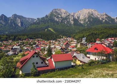 Sunny summer landscape with Bucegi mountains and Busteni ski resort in Romania.