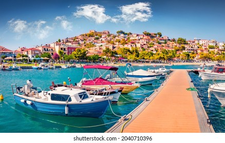 Sunny summer  view of Astros port. Wonderful morning seascape of Myrtoan Sea. Picturesque urban scene of Arcadia region, Greece, Europe. Traveling concept background.