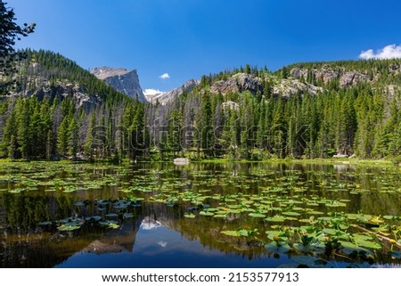 Sunny view of the beautiful the Louch lake with reflection and clear water at Rocky Mountain National Park, Colorado