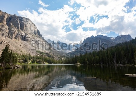 Sunny view of the beautiful the Louch lake with reflection and clear water at Rocky Mountain National Park, Colorado