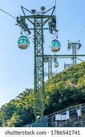 The sunny view of cable car and theme park near to ocean
