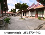 Sunny view of the central courtyard in the East-West Wing of Taipei Confucius Temple, highlighting traditional architecture and serene surroundings.