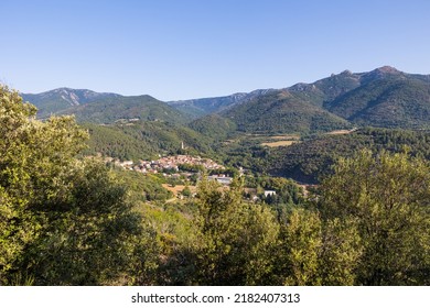 Sunny view of the medieval village of Olargues and the surrounding mountains of the Haut-Languedoc Regional Natural Park