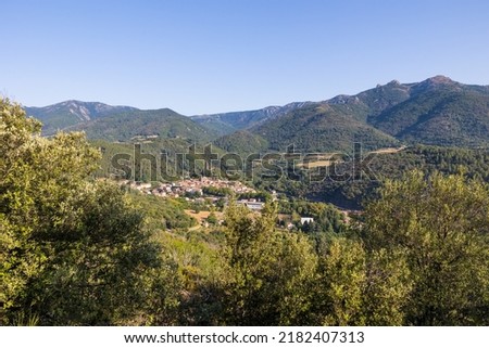 Sunny view of the medieval village of Olargues and the surrounding mountains of the Haut-Languedoc Regional Natural Park