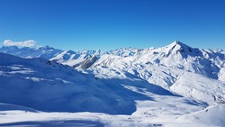Sunny View Over The Peaks Of White Mountains Of The French Alps From The Ski Area Les Trois Vallees With Clear Blue Sky