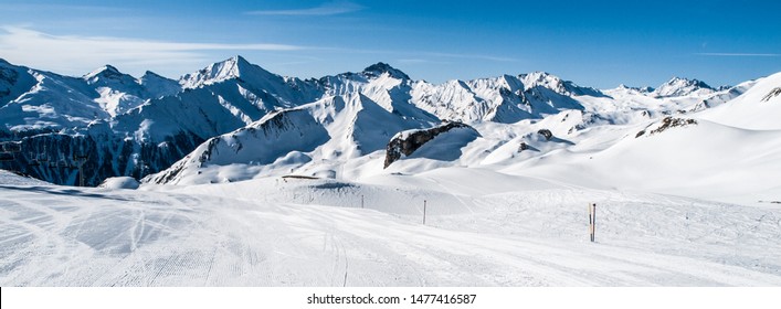 Sunny winter day in alpine ski resort with blue sky and bright white snow, Ischgl and Samnaun, Silvretta Arena, Austria - Switzerland