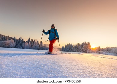 Sunny Winter Landscape With Man On Snowshoes In The Mountains.