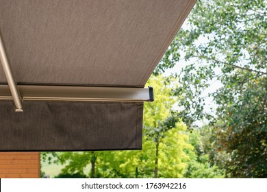 Sunprotecting awning from fabric material, residential house.