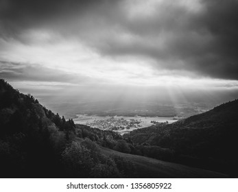 Sunrays breaking through clouds on a small Town in Bavaria. - Powered by Shutterstock - Get 15% off with code: PIKWIZARD15