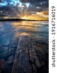 Sunrays burst through the cloudy skies along Carter Lake, located in Loveland Colorado, Larimer County