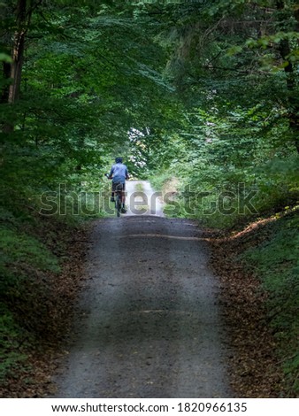 Similar – Radfahrer auf Waldweg