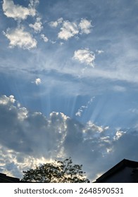 sunrays through the cloud, blue sunny day 