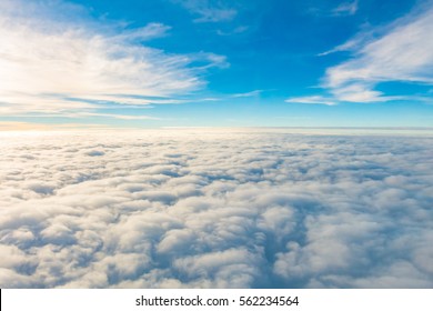 Sunrise above clouds from airplane window - Shutterstock ID 562234564