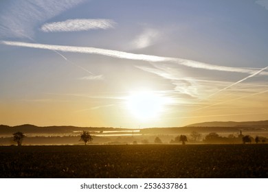 Sunrise, autumn, farmland, countryside, foggy, golden sunlight, early morning, trees, village, colourful sky - Powered by Shutterstock