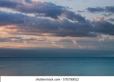 Sunrise Beach With Moody Clouds