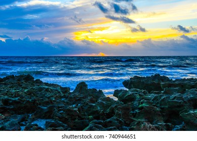 Sunrise Behind The Clouds On A Rocky Florida Beach