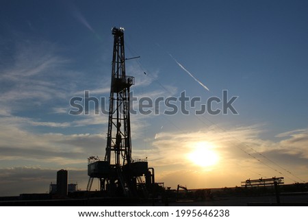 Sunrise behind a drilling rig in the Permian Basin
