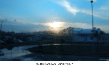 sunrise behind the glass window of the bus in highway