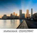 Sunrise from behind skyscrapers. Canary Wharf in London