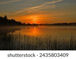 Sunrise at a Calm Lake, Sunrise Colour At A Idyllic Lake, A Wonderful Moment in The Morning At A Natural Lake, The Sun Rises Over a Lakescape, A Fantastic Start in The Day,  A Lake Scene By Sunrise,