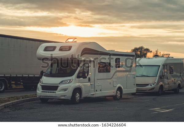 sunrise with campervan mobile home campervan\
fuels in gas station for an outdoor nomad lifestyle camper van\
caravan vehicle for van life holiday on motor home journey camping\
in the parking