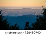 Sunrise captured in western North Carolina at Mt Mitchell State Park. Hues of pastel colors, with mist and fog slowly rising from the surrounding landscape. Purple Mountains Magesty.