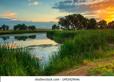 The Sunrise Casts Its Light Over The Wetlands Of Rocky Mountain Arsenal National Wildlife Refuge In Denver, Colorado