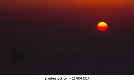 Sunrise Close Up View Over Dubai Skyline In The Morning, Aerial Top View From Dubai Marina Timelapse. Big Sun On Orange Sky Rise Over Fog Around Skyscrapers. United Arab Emirates