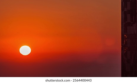 Sunrise close up view over Dubai skyline in the morning, aerial top view from downtown timelapse. Big sun on orange sky, foggy weather. United Arab Emirates - Powered by Shutterstock