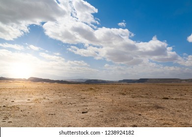 Sunrise With Clouds Over Barren Desert With Signs Of Cattle Near Capitol Reef National Park Utah