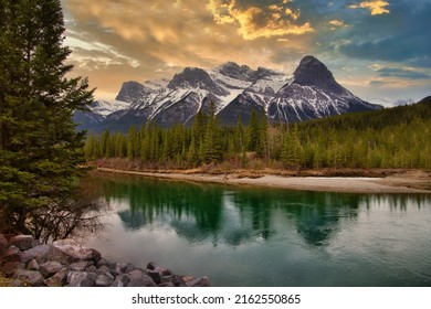 Sunrise Clouds Over Canmore Mountains And River