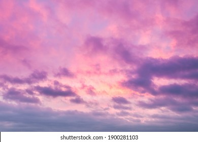 Sunrise clouds skyscape soft pink and purple tones. Majestic summer day cloudy weather. Romantic atmosphere of trendy background illustration desigh in warm pattern. Lovely rose sky panorama shot - Shutterstock ID 1900281103