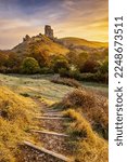 Sunrise at Corfe Castle in Dorset on a beautiful frosty morning in autumn.