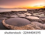 Sunrise at costline in Marsaskala salt pans, Malta.