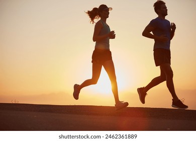 Sunrise, couple and running outdoor with silhouette of training, exercise and fitness with cardio for health. Wellness, sport and athlete with runner partner in nature in the morning with sprint - Powered by Shutterstock