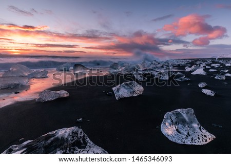 sunrise at Diamond Beach, near Glacier Lagoon during stormy weather - Iceland - Winter