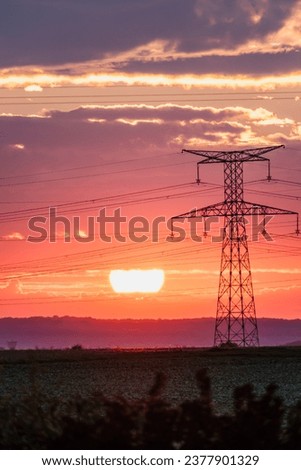 Sunrise with an electricity pylon and nature