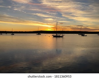 Sunrise At The Essex Docks In Ct. Highlighting The Rustic Sailboats On Their Moorings. ￼