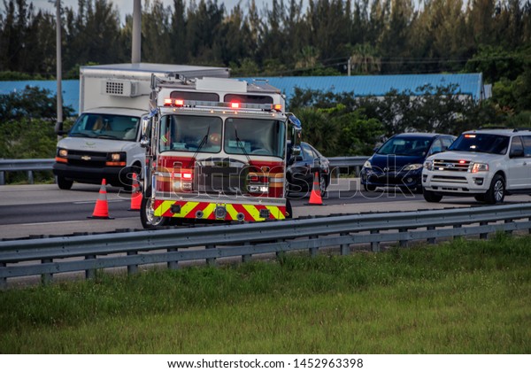 Sunrise, Florida/USA - July 16, 2019: Car\
Accident, some peoples was injured, three cars was smashed. Police\
Officer investigate accident. Sunrise Fire-Rescue Department\
workers maintained\
scene.