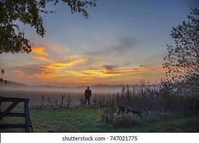 Sunrise With Fog On Farm In Missouri USA,with Farmer Looking At Land.