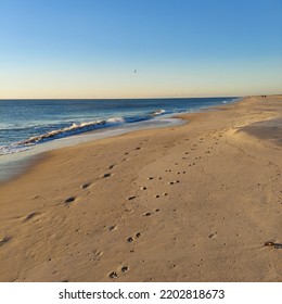 Sunrise Footprints On The Beach